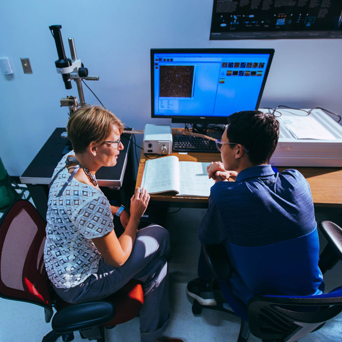 Student working with a faculty member in a laboratory