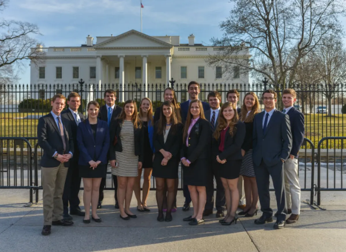 A group of students poses in front of the White House in Washington, D.C.