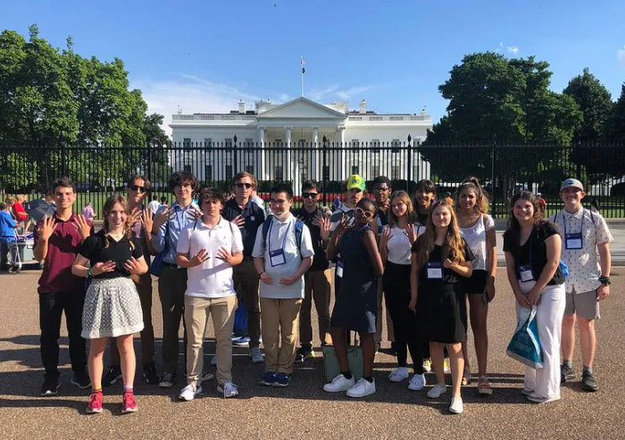 Students standing for a picture in front of the White House
