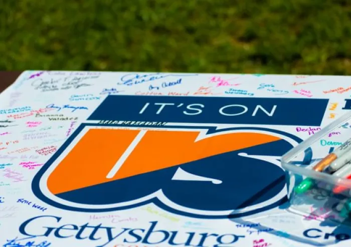 Its on us graphic on a table with signatures