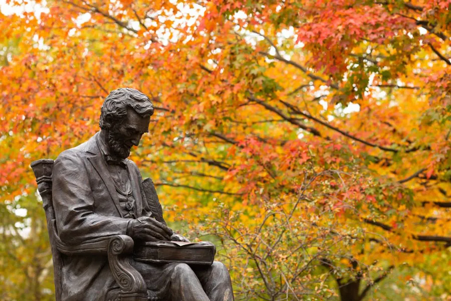 Abraham Lincoln statue with brillian fall foliage in background