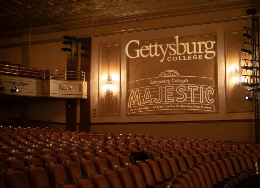 empty auditorium with lit branding on wall for Gettysburg College and Majestic Theater