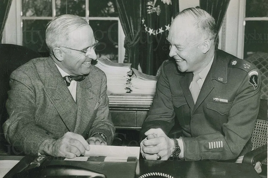 A photo of two men discussing