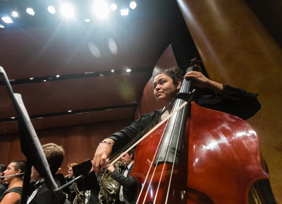 cello player plays with symphony