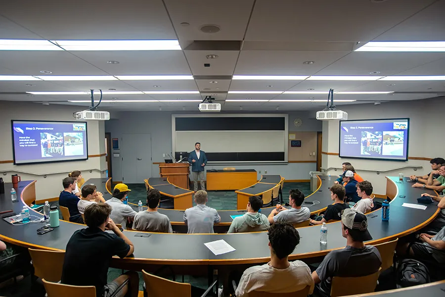 speaker addresses room of students