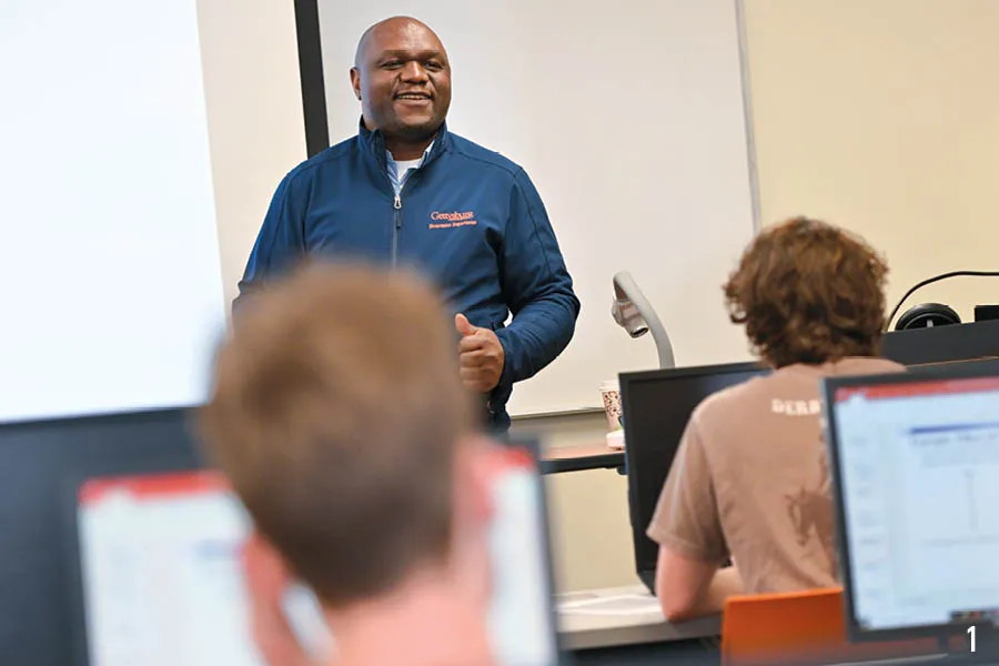 prof smiles at front of classroom