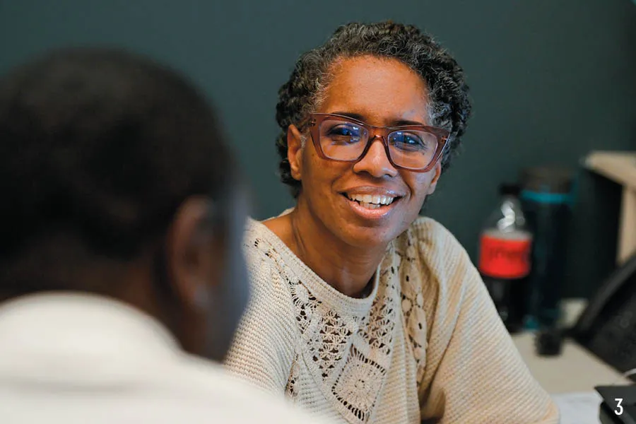 prof smiles at someone in foreground