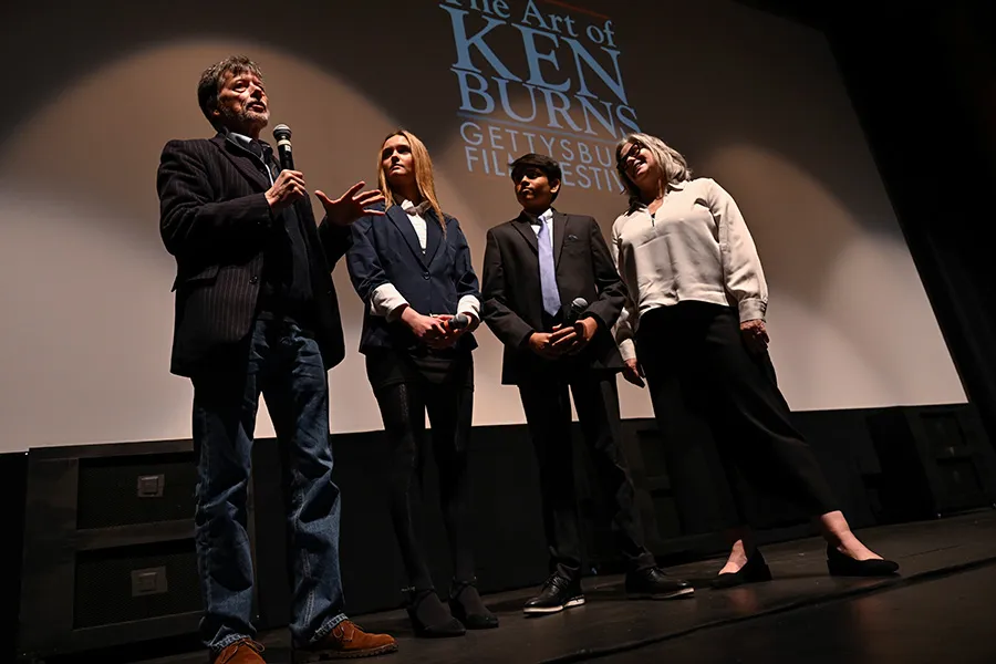 Ken Burns and three people on stage