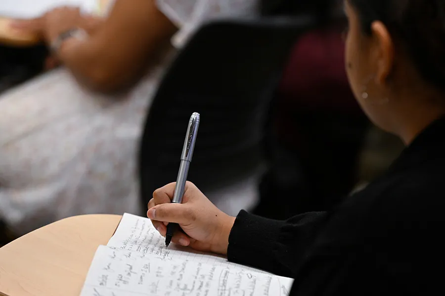 A student takes notes during class