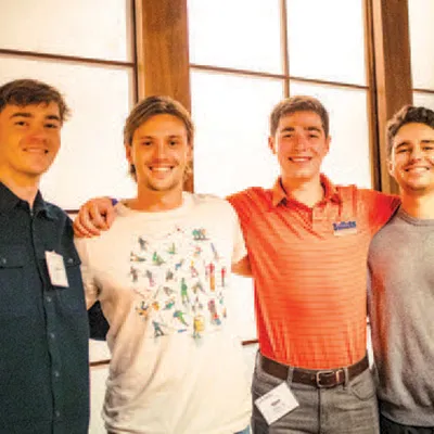 male students pose and smile for camera