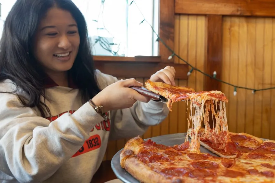 A student grabs a slice at Antica Napoli Pizza in Gettysburg.