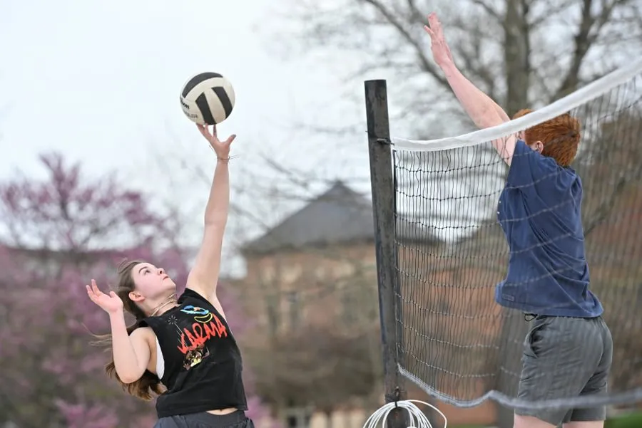 Students play intramural beach volleyball during the fall.