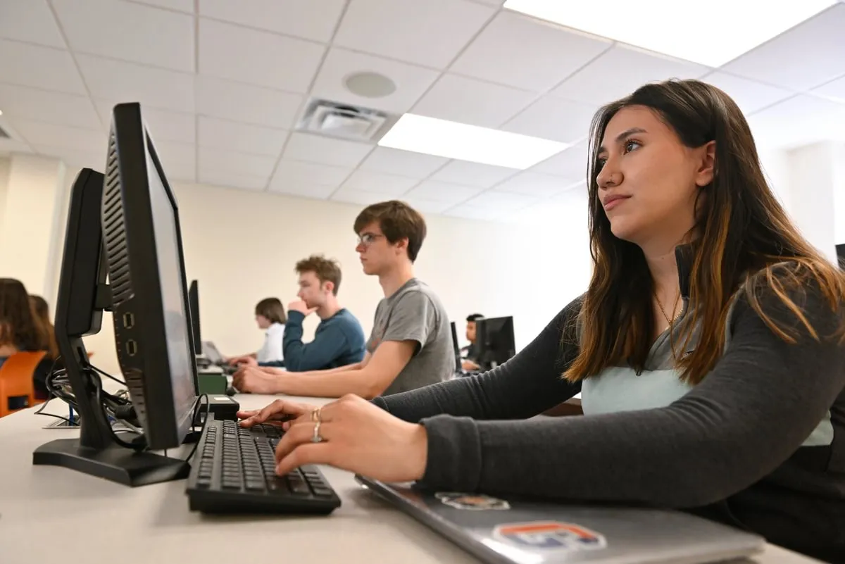female student works at computer