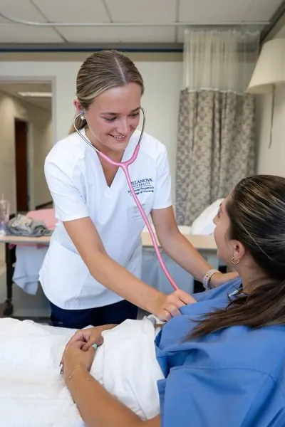 female villanova nursing student performs checkup on patient