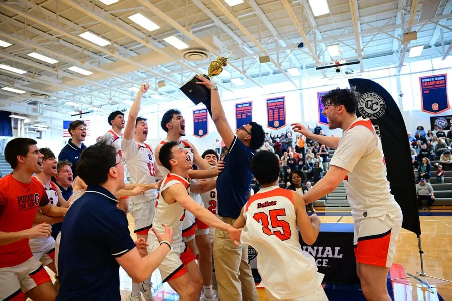 Men’s basketball team celebrates Centennial Conference championship win.