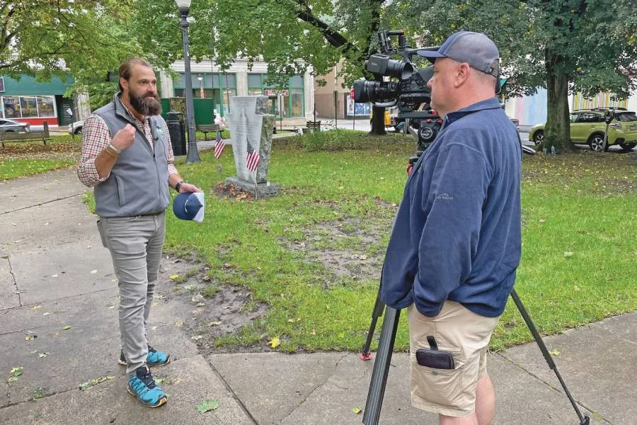 Reigner talks to a reporter during a tour of Johnstown with national leaders attending a Forum on Rural Development.