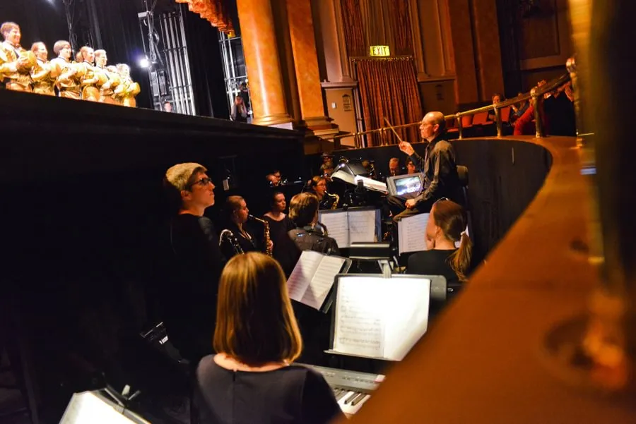 Music Prof. John “Buzz” Jones conducts the band during a showing of “A Chorus Line” at the Majestic Theater in 2013.