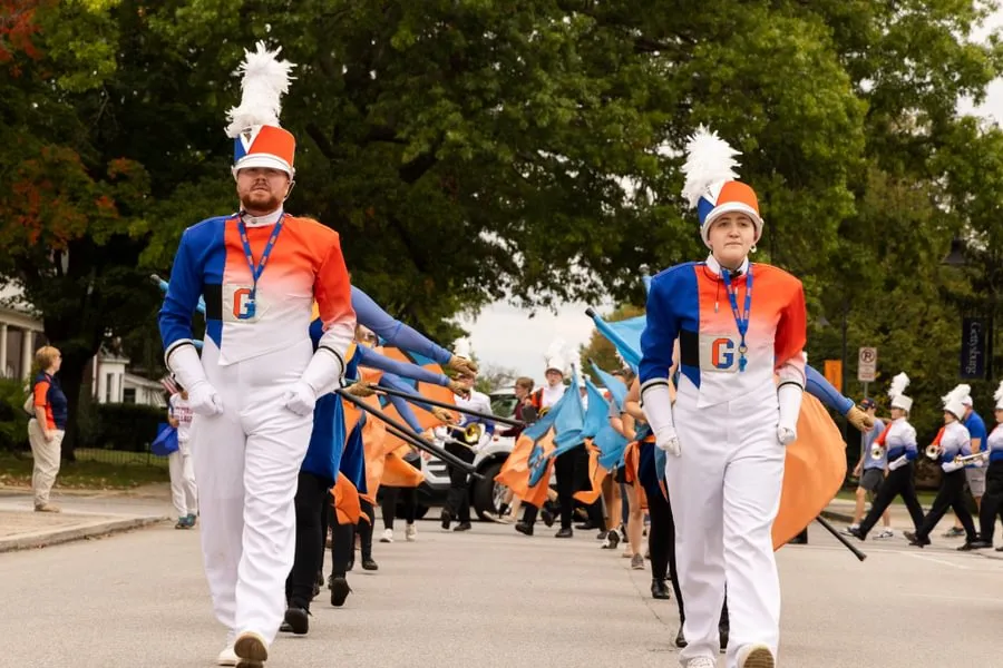 The Bullets Marching Band steps down the street on the way to the stadium during Homecoming Weekend