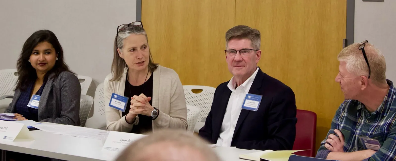 John Austin, Senior Fellow at the Eisenhower Institute, participate in a panel discussion alongside students during an Economic Transformation program session.