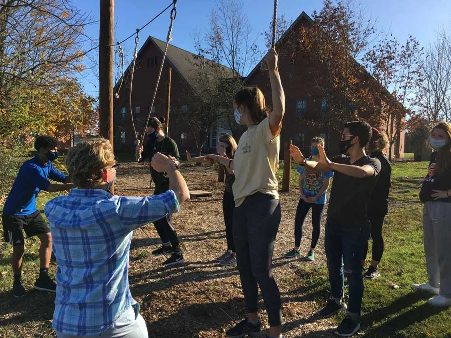 Students training with a low-hanging element