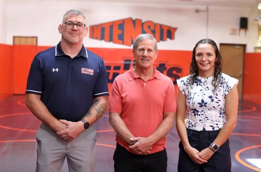 Bob Ortenzio ’79 (center) with Head Women’s Wrestling Coach Chris Haines and Assistant Coach Montana DeLawder.
