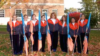 Gettysburg College color guard members pose with flags outdoors.