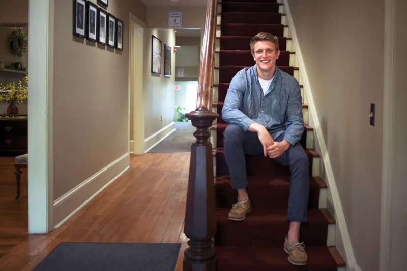 Gettysburg College alumnus Tyler Mann poses on a staircase.