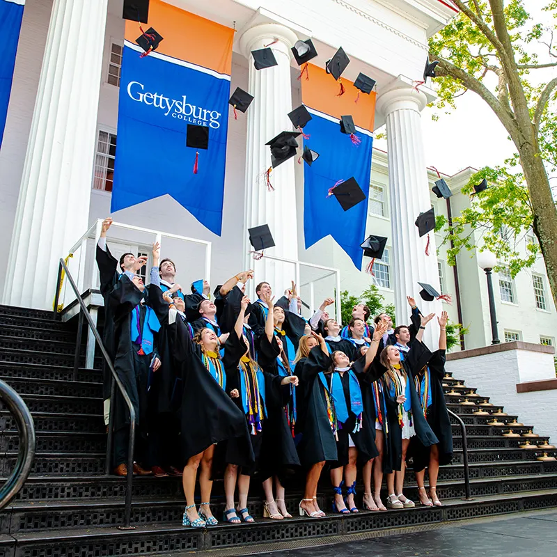 2023 graduates throwing their caps into the air
