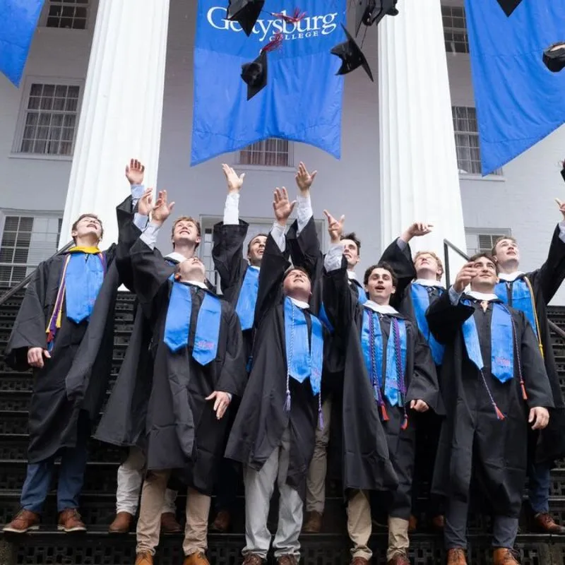 2025 graduates throwing their hats up in the air