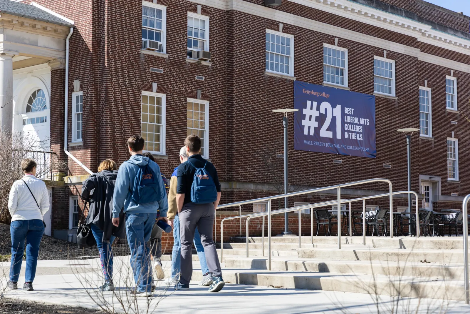 students walking by banner