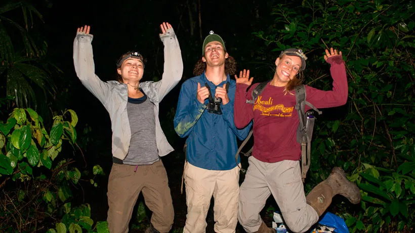 Three students jump in the air while doing research with Prof. Alex Trillo.
