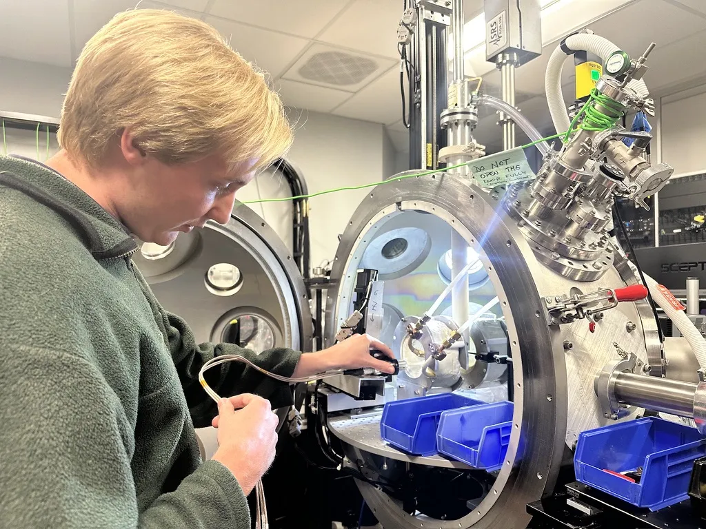 student using physics equipment in lab