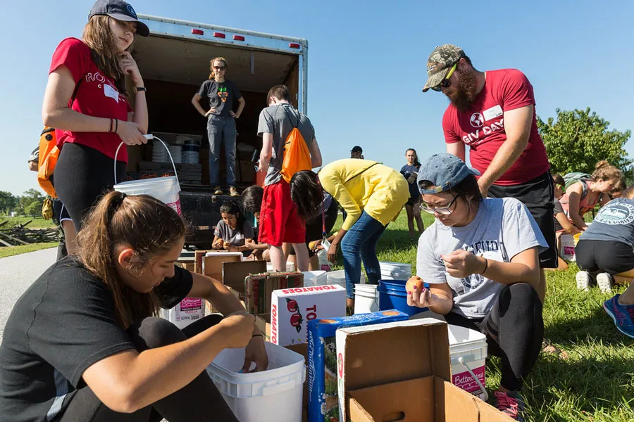 Students and families unload items.
