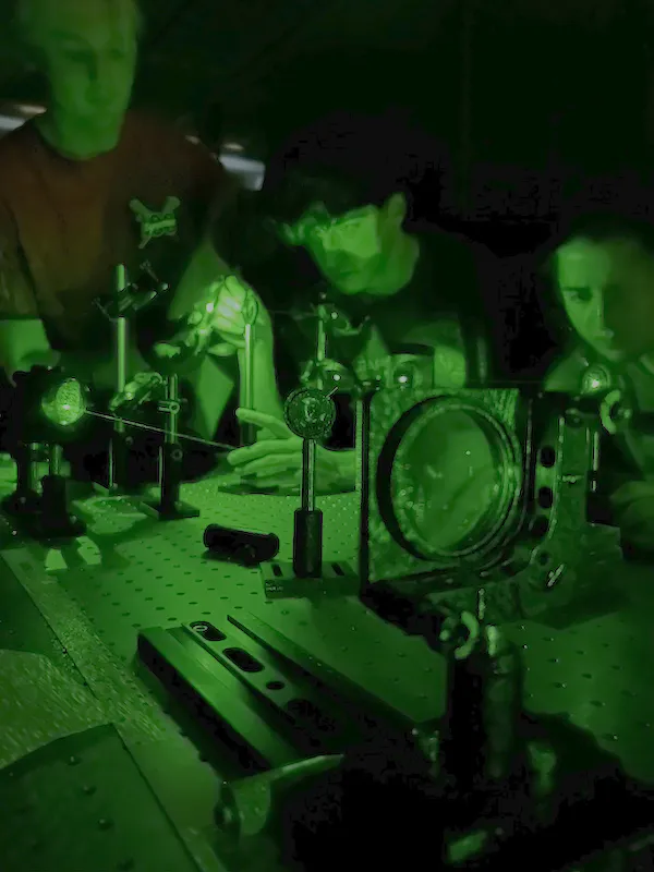 student work in Physics lab in green lighting