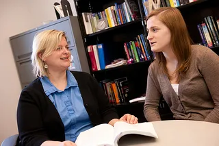Prof. Amy Dailey talks with a student.