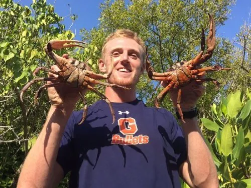 student holding up crabs
