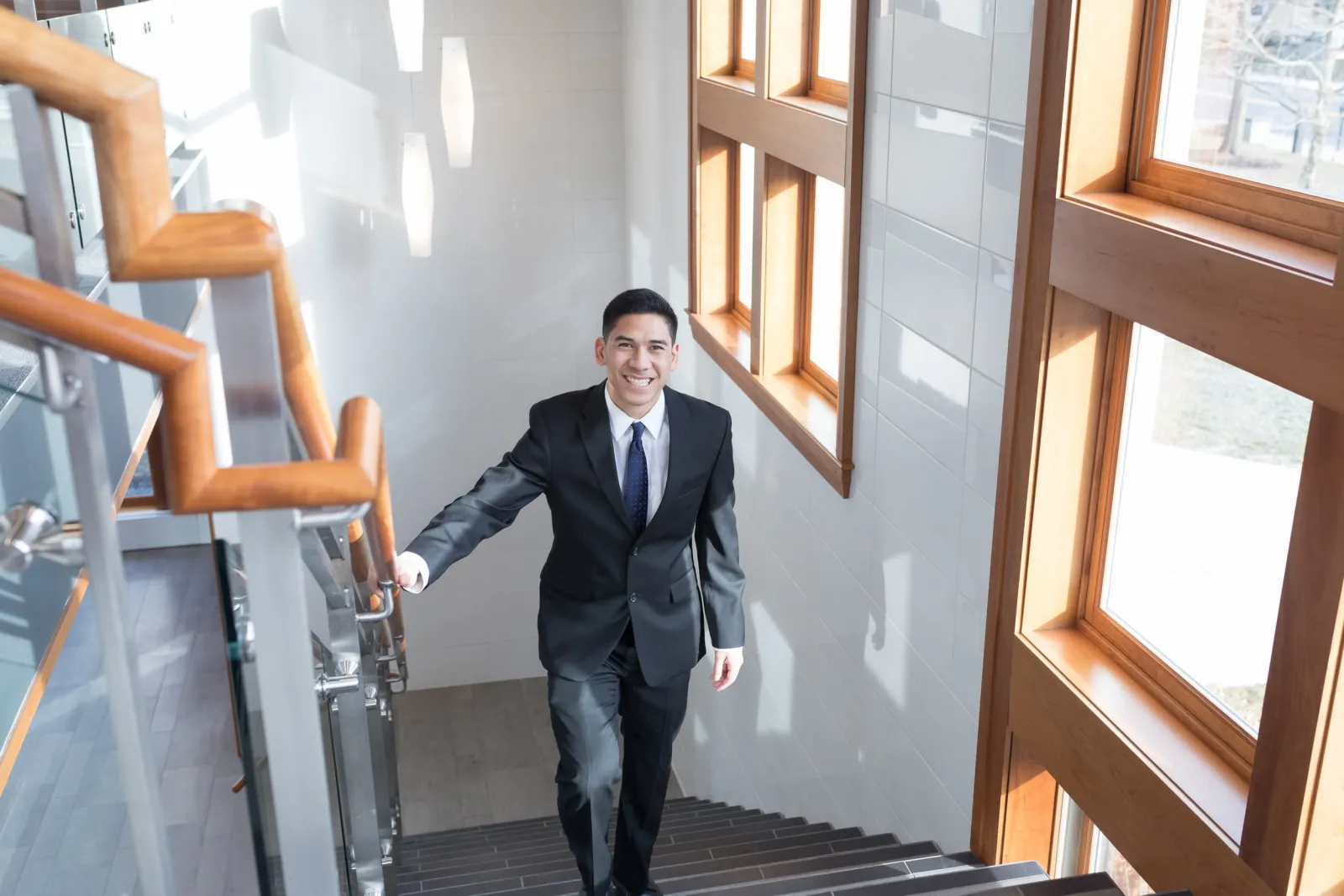 student in business attire walks up steps