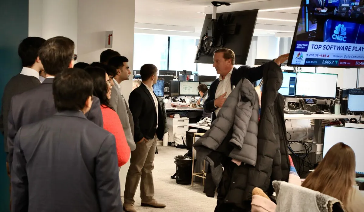Economics students visit with investors.