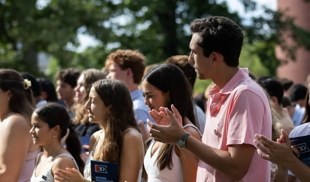 students applaud in crowd