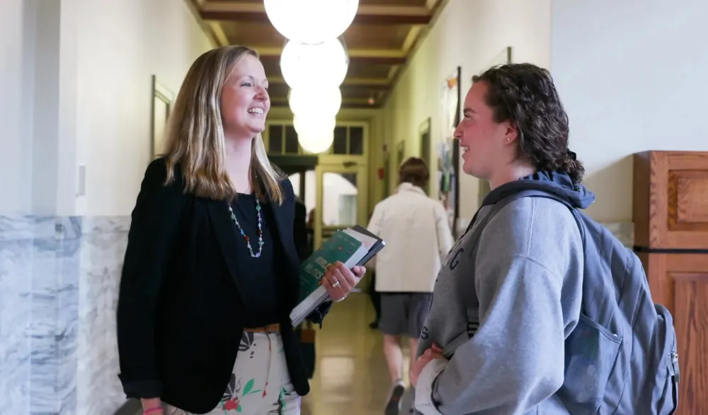 Prof and student connect in hallway