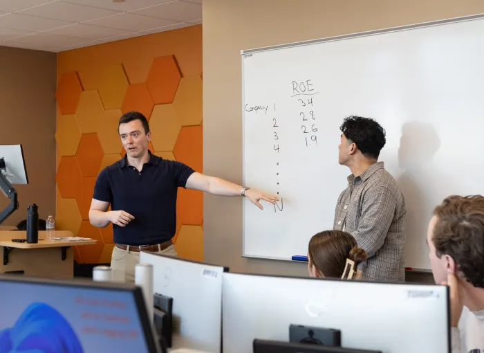 students present at white boards