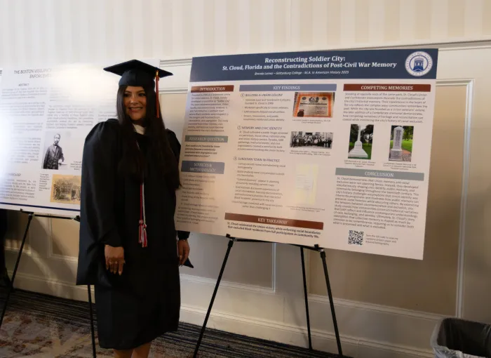 student with project poster