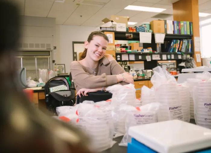 student poses in lab