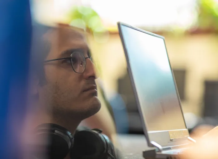reflection of student working at laptop