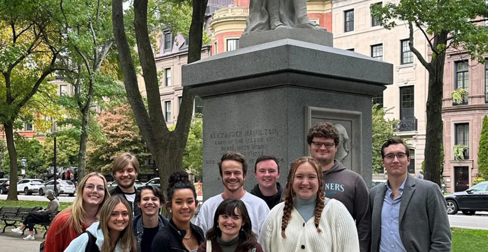 Political Science majors standing in front of a statue om Boston