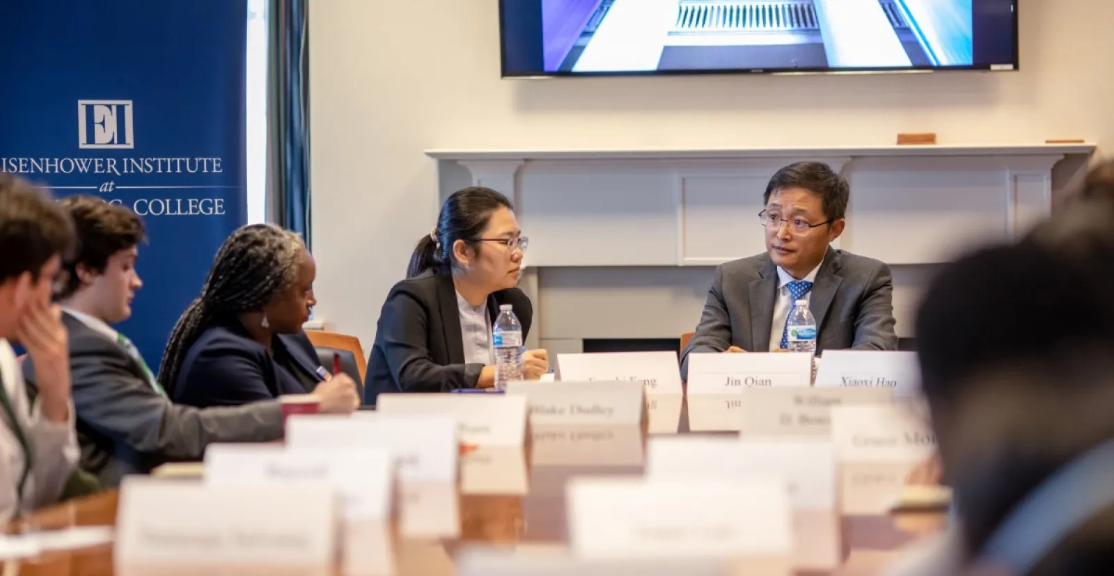 students sit at table with Chinese dignitary