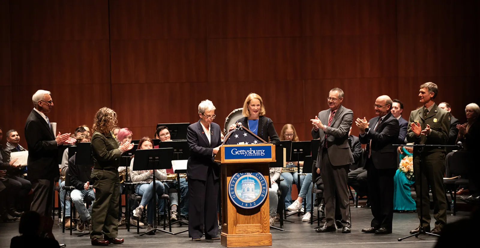 Susan Eisenhower, founder of the Eisenhower Institute, recieving the American flag