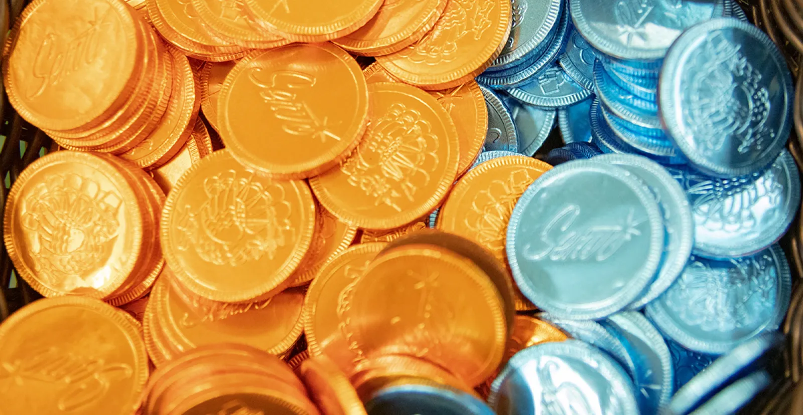 Chocolate candy rounds wrapped in orange and blue foil