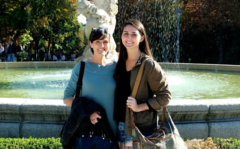 Cathie Wood and Caroline Wood standing in front of a water fountain