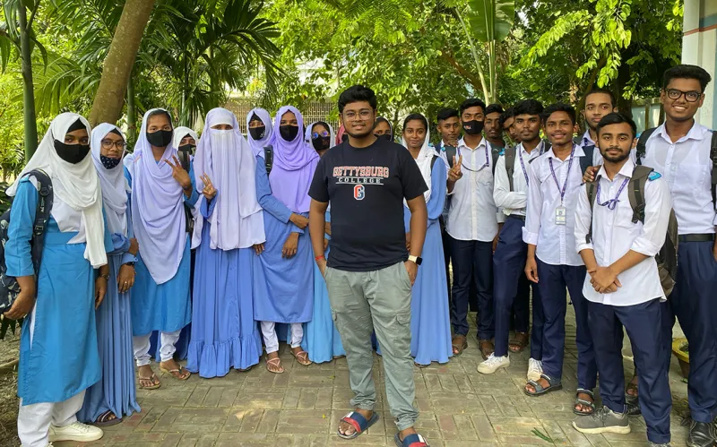 Pronob Sarker ’26 with students.